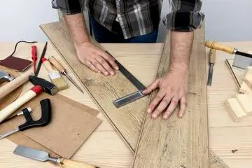 high-view-holding-wood-planks-carpentry-workshop-concept (1)