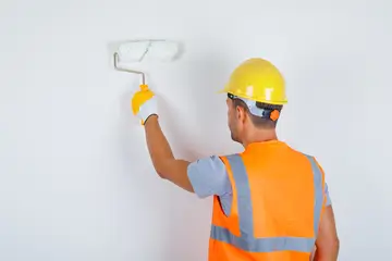 male-builder-uniform-helmet-gloves-painting-wall-with-roller-back-view (1)